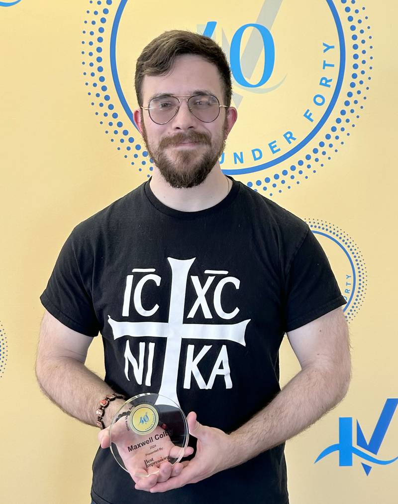 Colby Maxwell poses for a photo with his 40 Under Forty plaque.