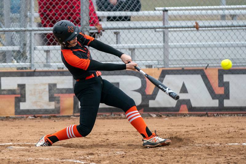 St.Charles East's Hayden Sujack (21) slaps an infield single against Yorkville during a softball game at St.Charles East High School on Wednesday, Mar 22, 2023.