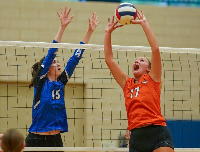 Wheaton Warrenville South's Rebecca Bellows (17) sets the ball while Geneva’s Fiona Turnbull (15) defends the net during a volleyball match at Geneva High School on Tuesday, Sep 5, 2023.