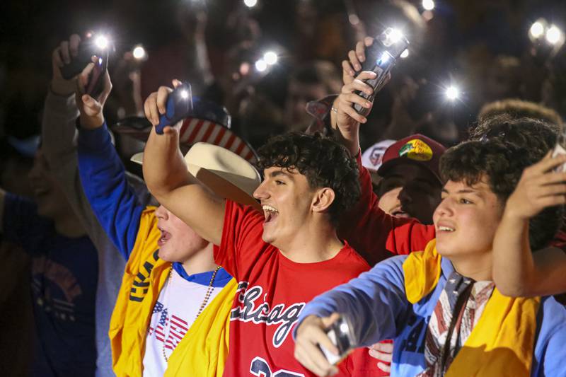 The Oswego student section hold up their lit phones during pregame introductions before their basketball game between Yorkville at Oswego, Feb 7, 2026 in Oswego.