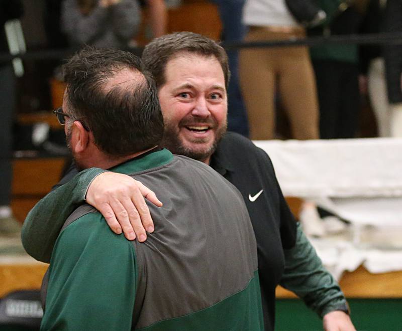 St. Bede boys basketball head coach Brian Hansen hugs assistant coach Mike Bima after defeating Marquette in the Class 1A Regional semifinal on Wednesday, Feb. 22, 2023 at Midland High School.