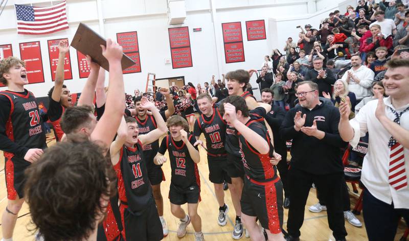 Members of the Indian Creek boys basketball team hoist the Class 1A Sectional plaque after defeating Marquette on Friday, March 6, 2026 at Amboy High School.