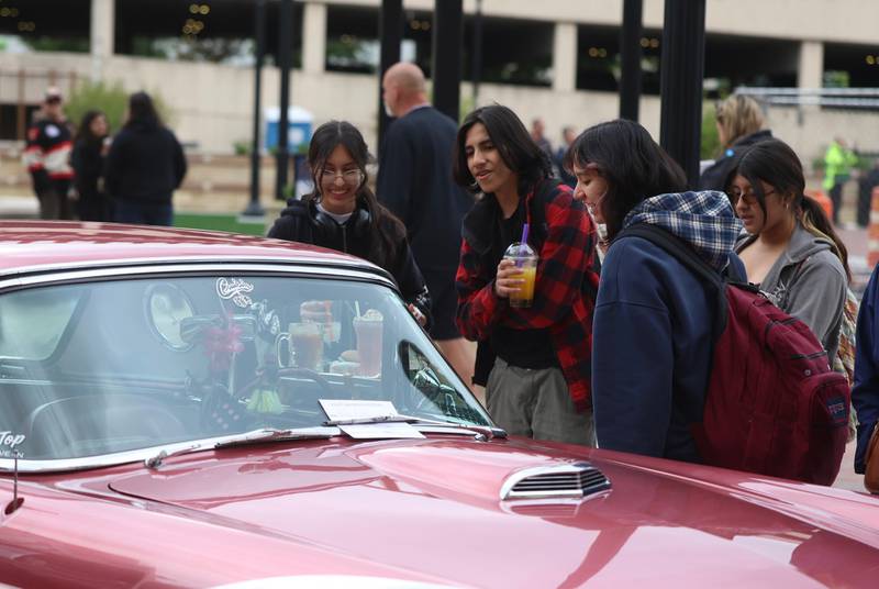 Visitors check out the car show at the opening of the new City Square in downtown Joliet on Friday, May 1, 2026.