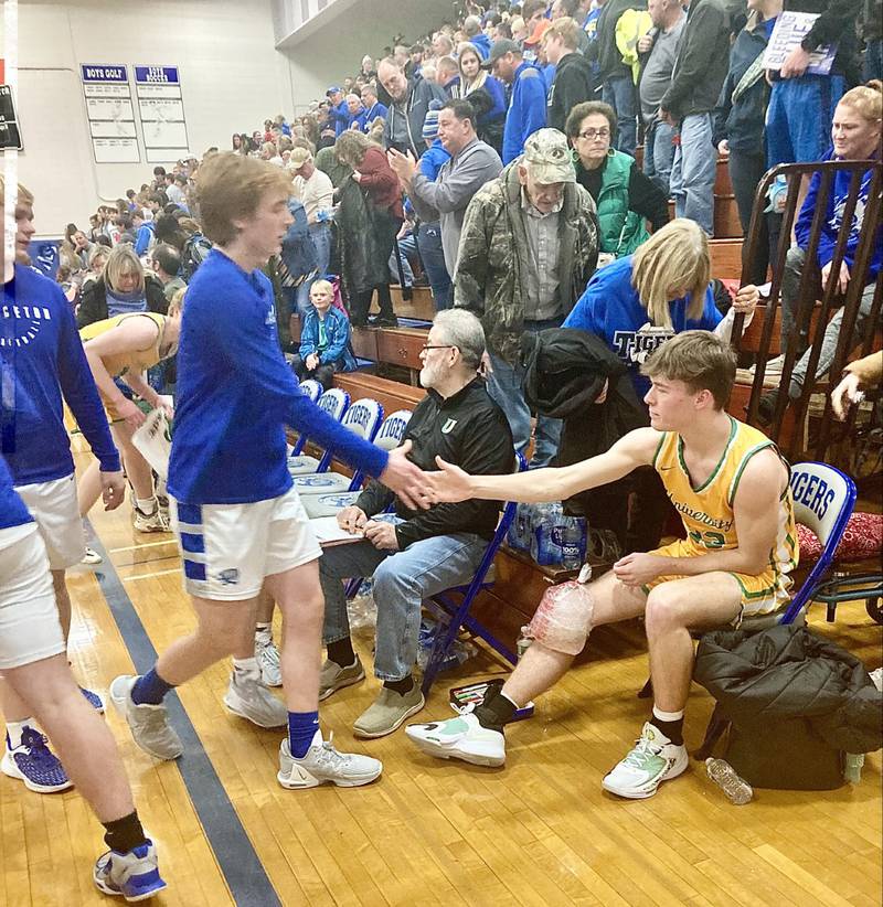 Jimmy Starkey and each Princeton player individually shook hands of injured U-High player Ty Blake following Saturday's game at Prouty Gym. U-High coach Andrew McDowell said Blake's knee was expected to be OK and appreciated the Tigers' show of sportsmanship.