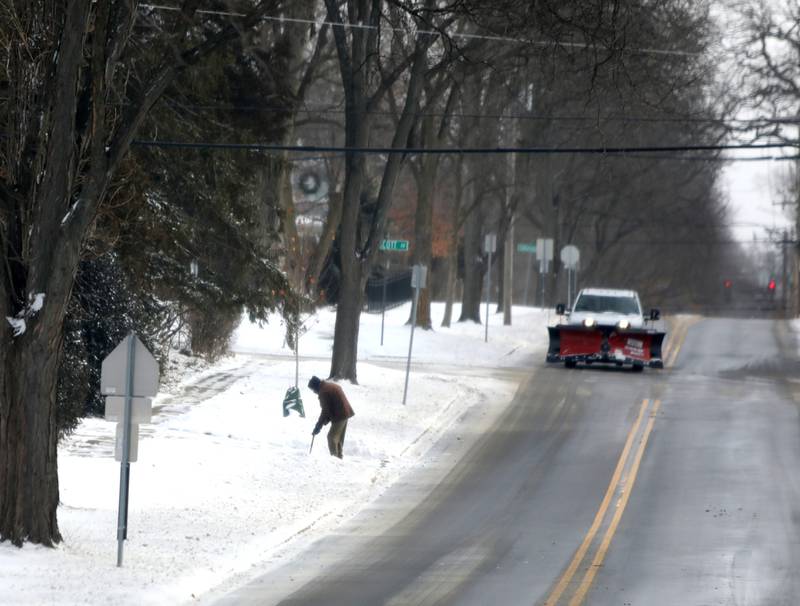 A resident shovels their driveway in Downers Grove as temperatures dip below zero on Friday, Dec. 23, 2022.