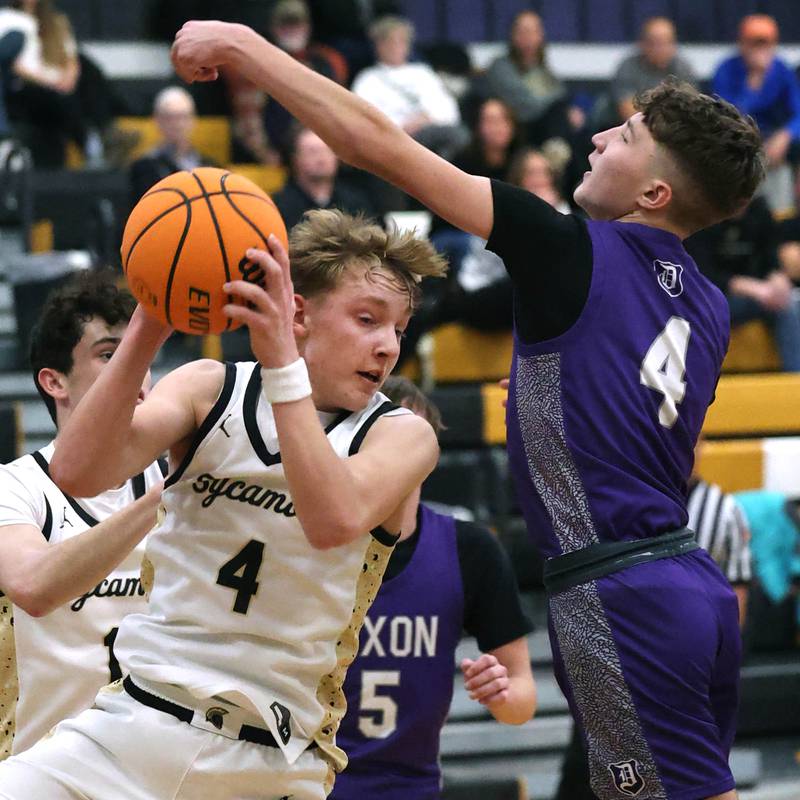 Sycamore's Isaiah Feuerbach grabs a rebound in front of Dixon's Brody Nicklaus during their game Tuesday, Jan. 14, 2025, at Sycamore High School.