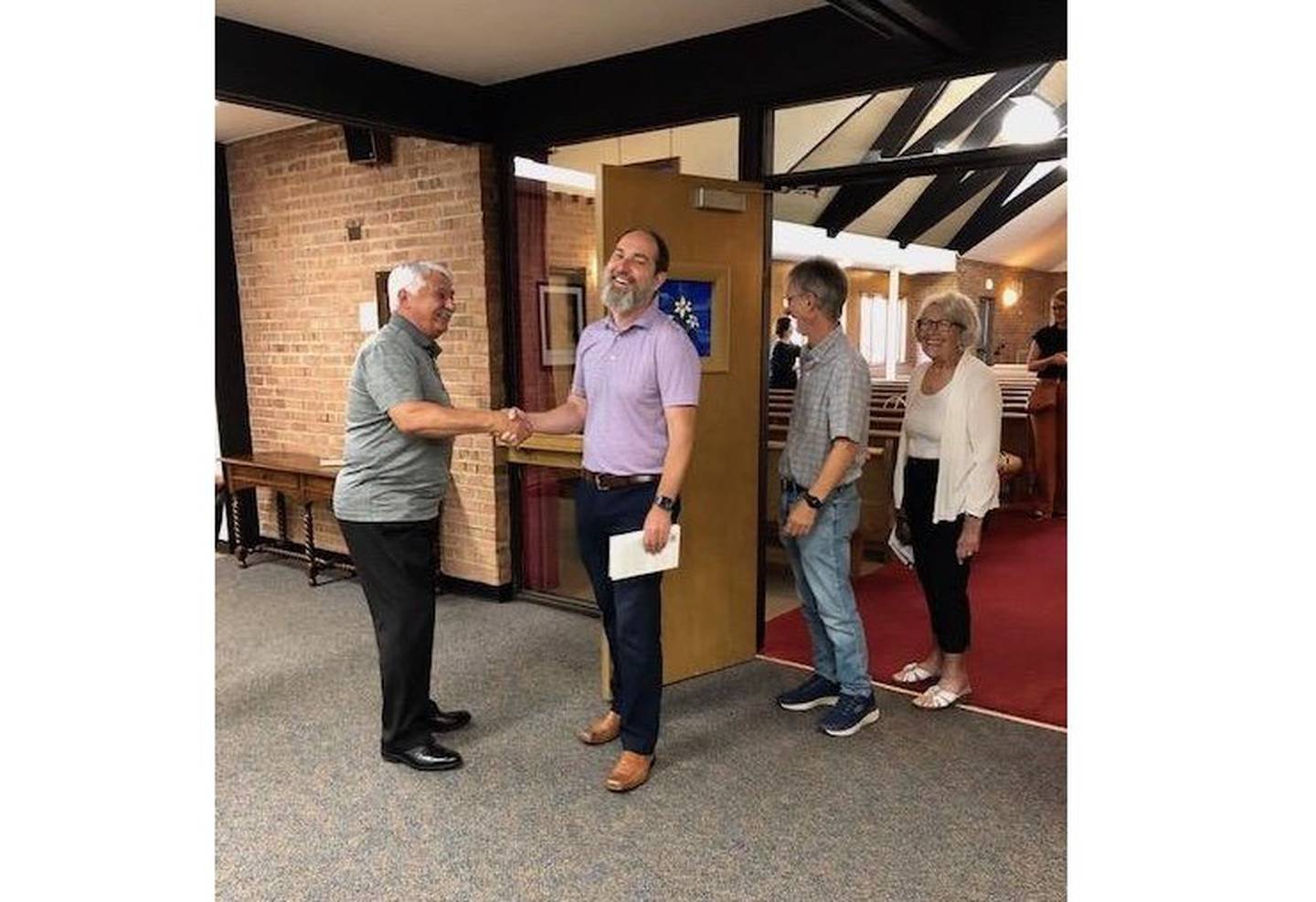 The Rev. Jake Bradley, pastor at Church of the Good Shepherd Evangelical Covenant, second from left, chats with parishioner Tom Carten as fellow church members Keith Bielema and Nancy Carten look on. The Church of the Good Shepherd Evangelical Covenant in Joliet will celebrate its 150th anniversary in September with three days of events.