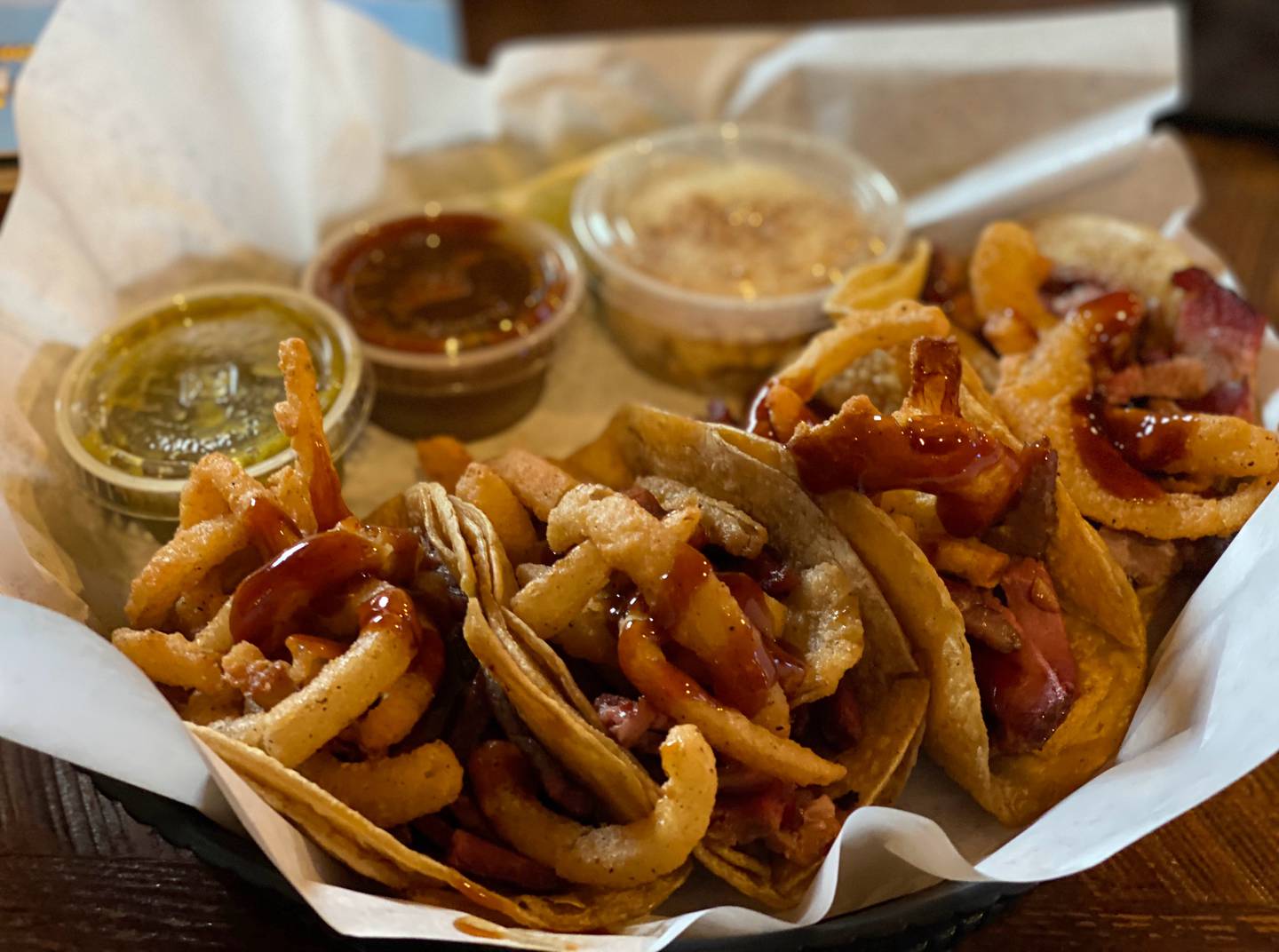 My fellow diner order the brisket tacos, which came with sliced barbecue brisket topped with fried onion straws. All of the taco options came with side of esquites, which is Mexican street corn served off the cob and in a cup.