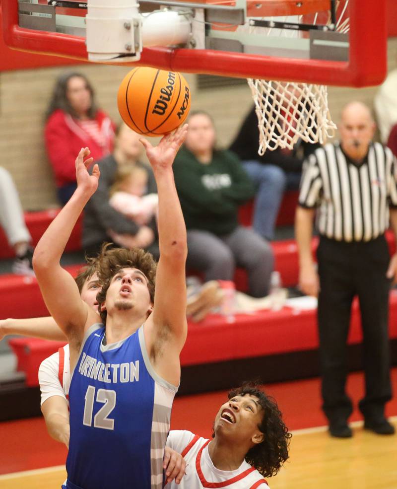 Princeton's Asa Gartin lets go of a layup over Ottawa's Hezekiah Joachim on Monday, Feb. 3, 2025 in Kingman Gymnasium at Ottawa High School.
