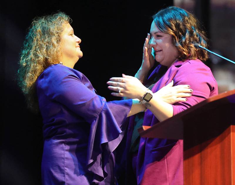 Jennifer Yochem, (left) 2024 Athena Award winner, hugs an emotional Devyn Grzywa after she was announced as this years recipient of the Athena Award Thursday, Oct. 16, 2025, during the 35th annual Athena and Women of Accomplishment Award Reception at the Egyptian Theatre in DeKalb.winner of the 2025 Athena Award, Devyn Grzywa