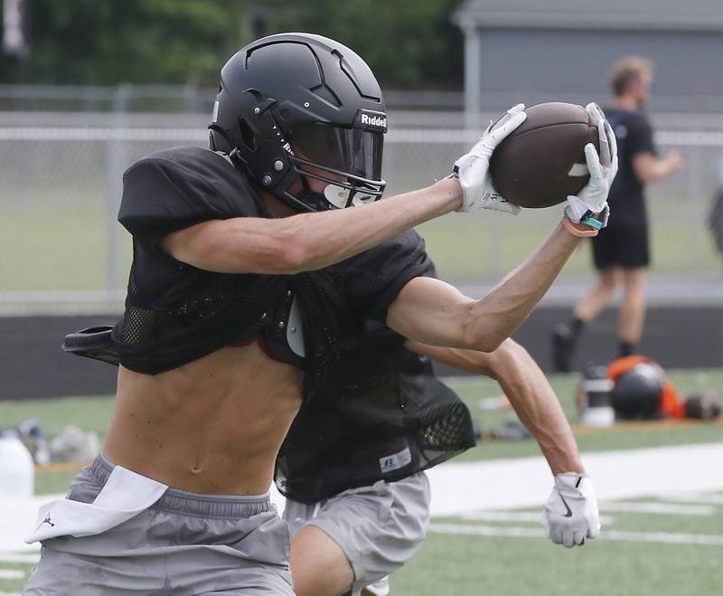 McHenry’s Dayton Warren catches a pass during football practice on Thursday, July 24, 2025, at McCracken Field, in McHenry.