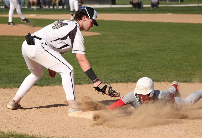 Ottawa's Jacob Rosetto dives back into first ahead of the tag of Sycamore's Jack Block during their game Tuesday, May 6, 2025, at the Sycamore Community Sports Complex.