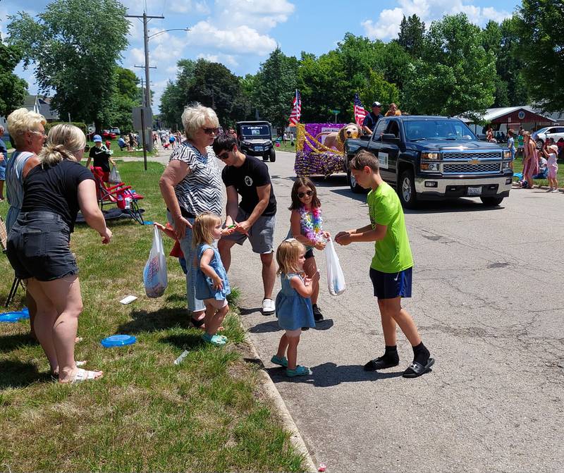 Candy is handed out Sunday, July 9, 2023, to parade goers during the Marseilles Fun Days parade.