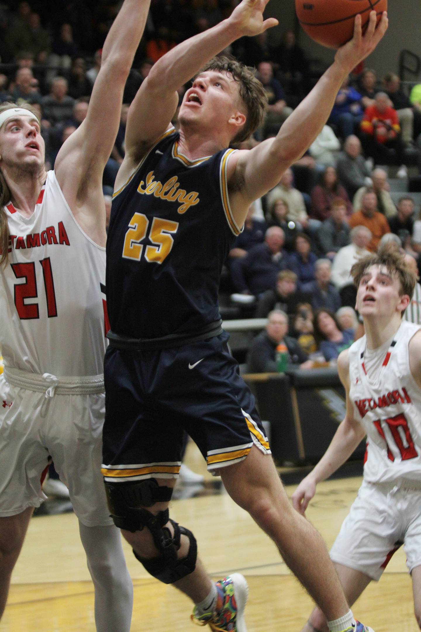 Sterling's Kael Ryan (25) shoots over Metamora's Ethan Kizer in the Class 3A Galesburg Sectional semifinals on Wednesday, March 1, 2023.