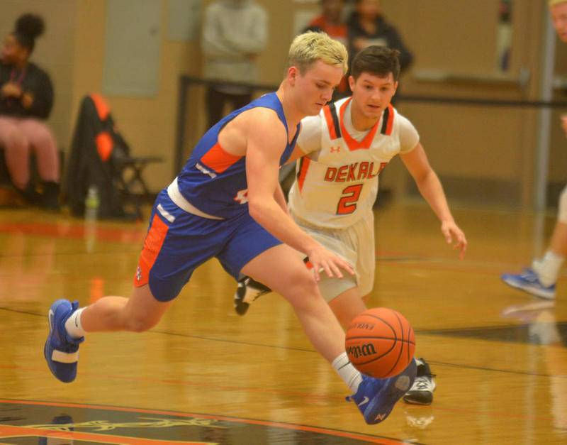 Genoa-Kingston guard Justin Peters (left) chases down a loose ball with DeKalb's Avery Medina in pursuit in the third quarter Wednesday in DeKalb.