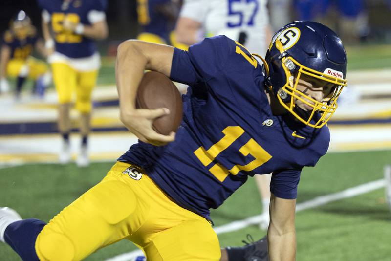 Sterling’s Brady Berlin stays on his feet while running the ball against Quincy Friday, Oct. 17, 2025.