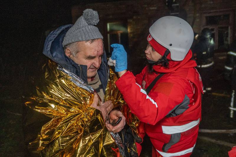 A paramedic gives first aid to a resident who was injured in a Russian airstrike in Kharkiv, Ukraine, late Sunday, Nov. 23, 2025. (AP Photo/Andrii Marienko)