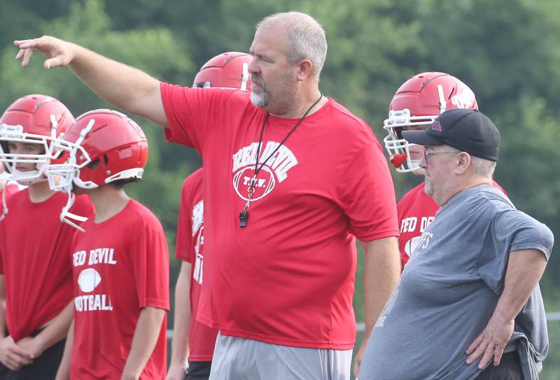 Hall High School football coach Nick Sterling talks to former coach Randy Tieman during camp on Thursday, July 24, 2025 at Hall High School.