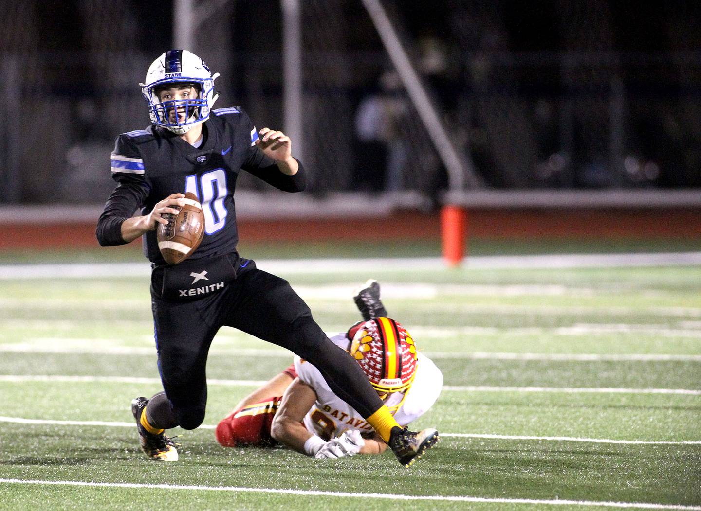 St. Charles North quarterback Ethan Plumb looks to pass the ball during a game against Batavia at St. Charles North on Friday, Oct. 22, 2021.