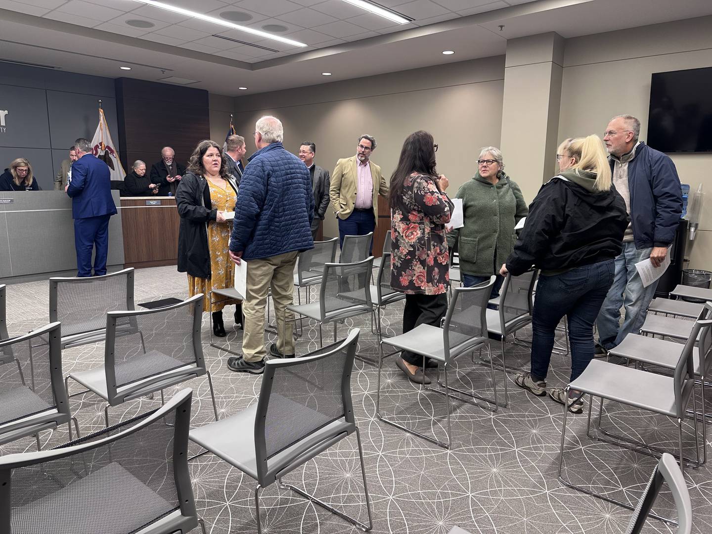 Audience members mingle at the Lakemoor Village Board April 1, 2025, before trustees voted to allow a solar farm to operate on a golf course that will be annexed into town.