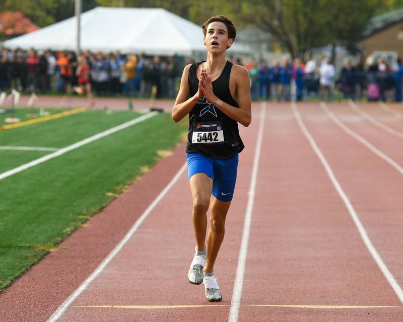 Samuel Hill of St. Charles North celebrates as he crosses the finish line during the DuKane Conference meet on Saturday Oct. 18, 2025, held at Lake Park High School east campus where he finished 1st with a time of 14:57.6.