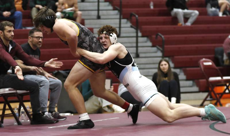Richmond-Burton’s Shane Falasca fights to get out of the grasp of Marian Central’s Dan French in the 215-pound championship match of the IHSA 1A Marengo Wrestling Regional on Saturday, Feb. 8, 2025, at Marengo High School.