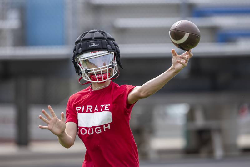Ottawa High School quarterback Mark Munson warms up prior to the first of several matches against other schools during a multiple high school practice football meet at Princeton High School on July 20, 2024.