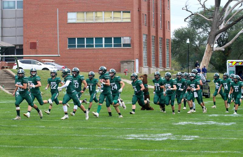 The St. Bede football team runs onto the field during the Homecoming game on Saturday, Sept. 28, 2024 at St. Bede Academy.