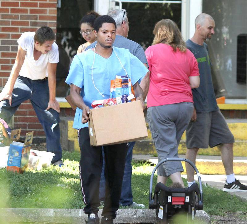 Residents are able to remove their belongings from Ridgebrook Apartments at 808 Ridge Drive in DeKalb Wednesday morning a day after a fire displaced them from the complex.