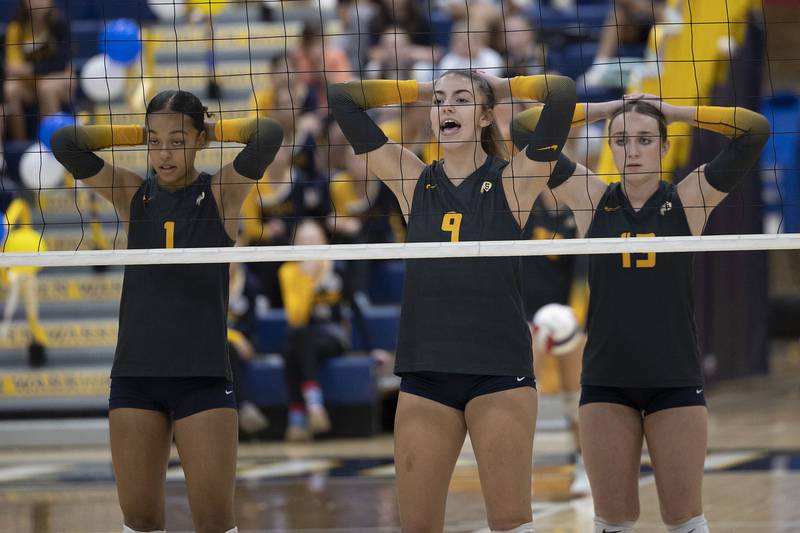 Sterling’s Nia Harris (left), Megan Stutzke and Sydney Giffin wait for a serve against Alleman Thursday, Sept. 25, 2025.