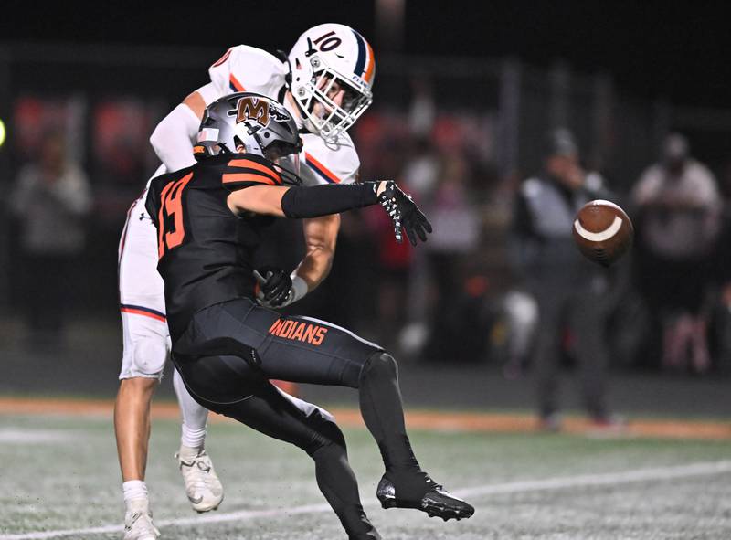 Minooka's Blake Larson (19) breaks a pass intended for Oswego's MARIANO VELASCO (10) during the conference game on Friday, OCT. 10, 2025, at Minooka.