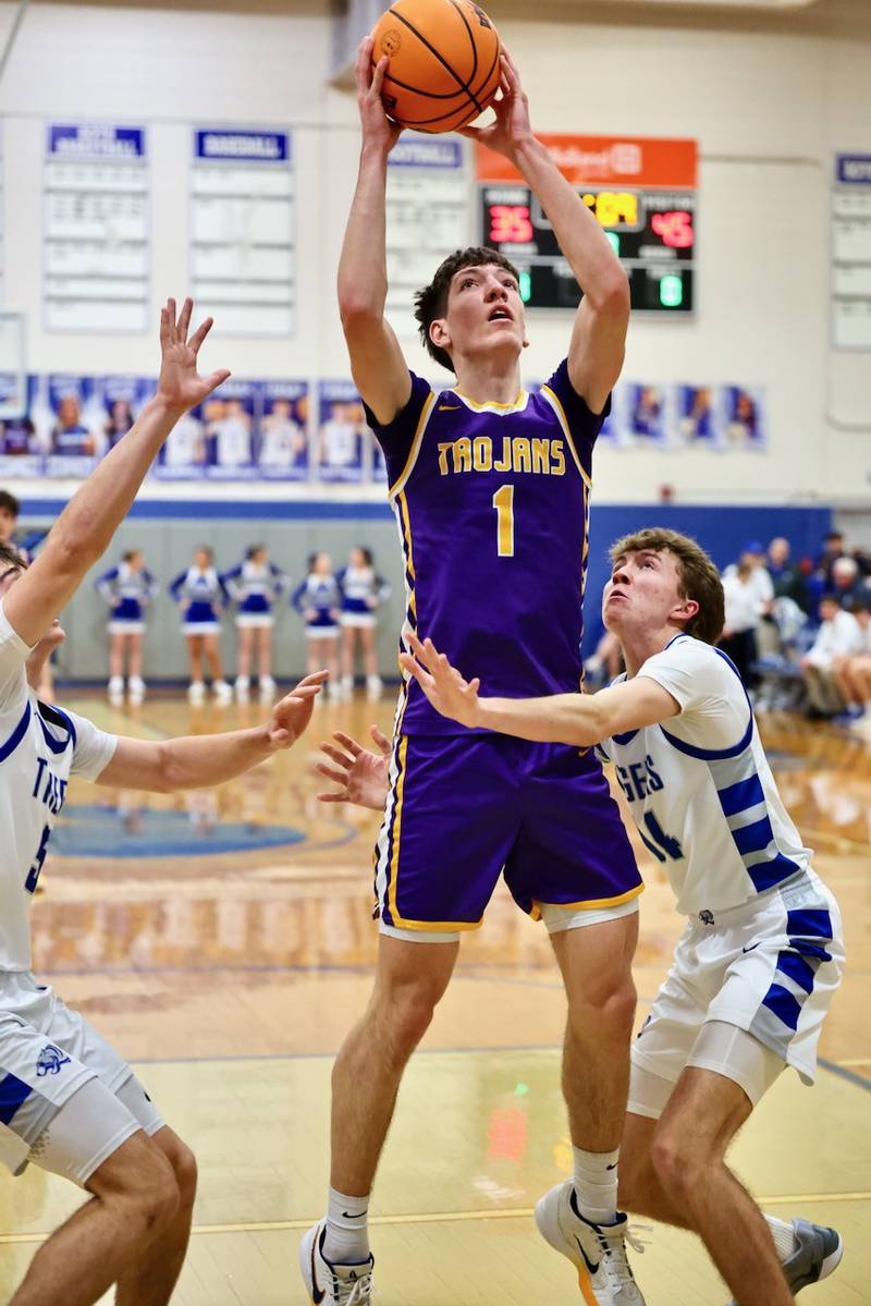 Mendota's Cole Tillman shoots over Princeton's Jackson Mason for a second half Friday night at Prouty Gym. He scored 32 points, including his 1,000th career point, to lead the Trojans to an 80-54 win.