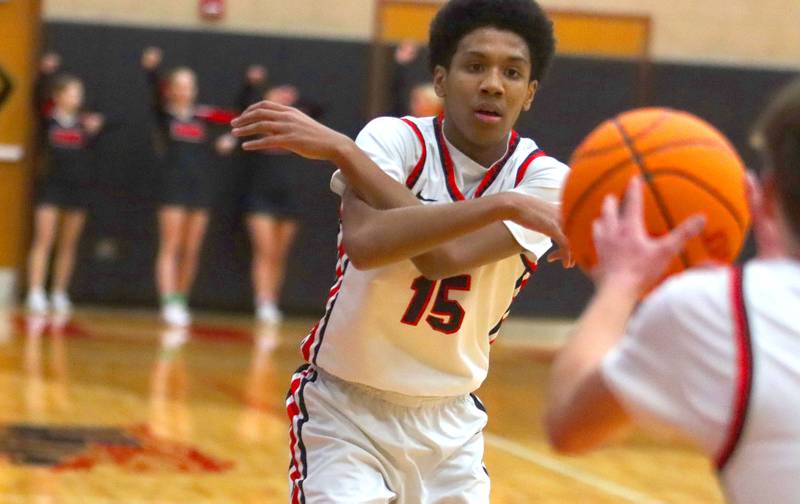 Huntley’s Isaac Muze dishes the ball against Hampshire in varsity boys basketball on Friday, Dec. 19, 2025, at Huntley High School in Huntley.