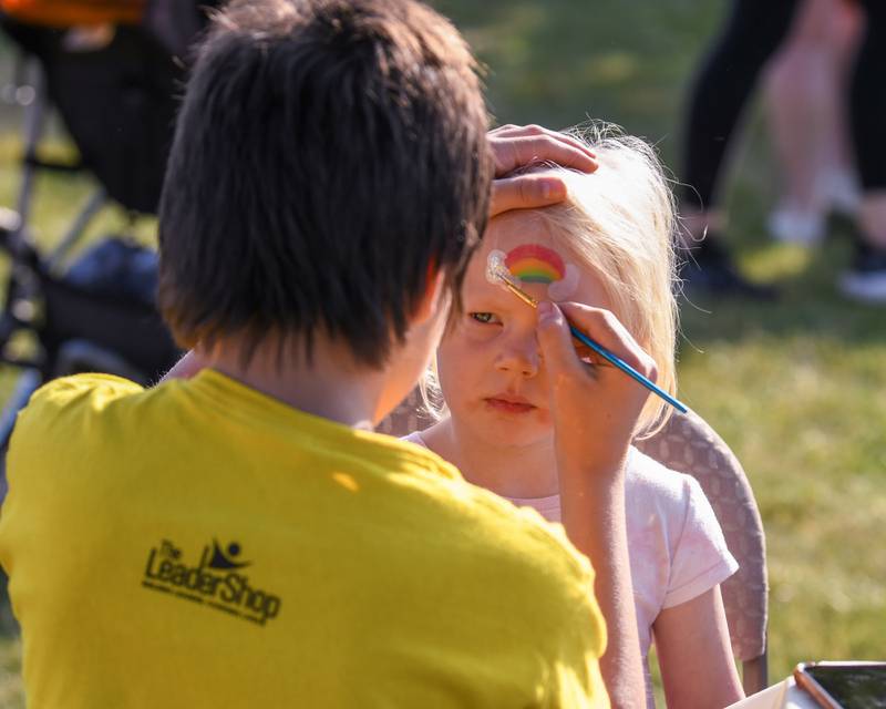 Mia Ward, 3 years old, of La Grange gets a rainbow painted on her face before the start of the Leadershop 5k run walk event held in La Grange on Friday June 9, 2023