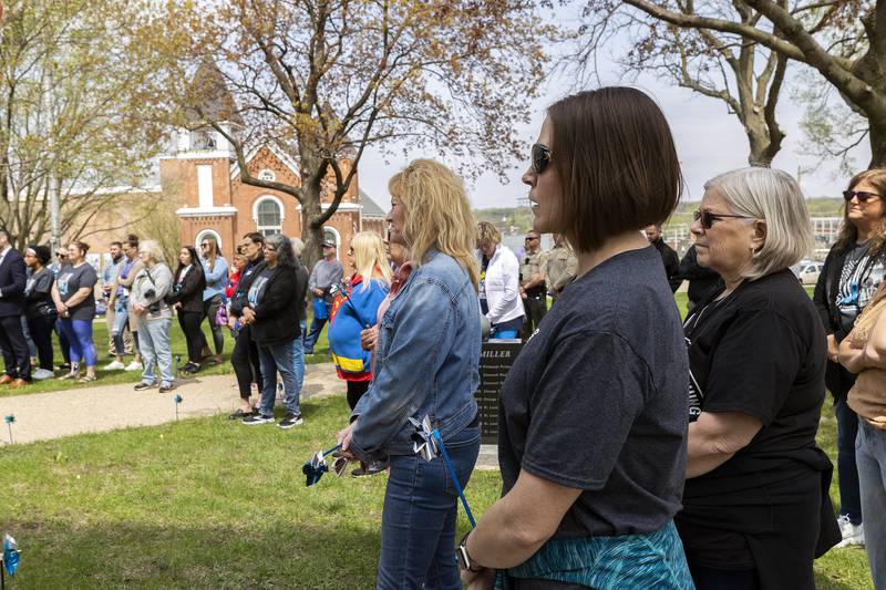 Approximately 100 people attend “Hands Around the Courthouse” Friday, April 25, 2025, to bring attention to Child Abuse Prevention Month. The blue pinwheel is a national symbol of child abuse prevention.