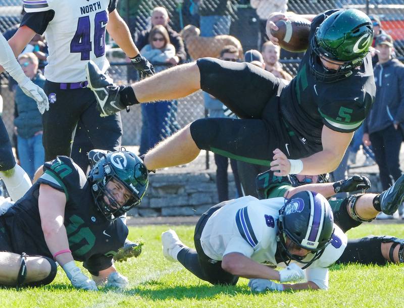 Glenbard West's Jack Oberhofer (5) dives into the end zone for a touchdown against Downers Grove North during a game on Oct. 8, 2022 at Glenbard West High School in Glen Ellyn.
