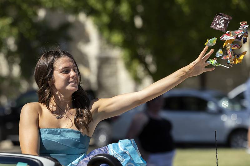Ellen Pappocia chucks candy from a car Friday, Sept. 20, 2024, during Newman High School’s homecoming parade.