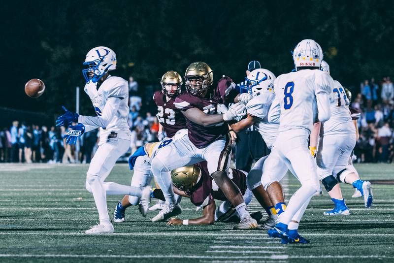 St. Ignatius sophomore Justin Scott, center, pushes past De La Salle's offensive line on Oct. 1. Scott has 12 collegiate scholarship offers.