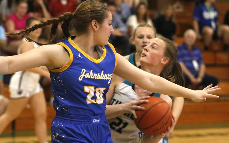 Woodstock North's Addison Udelhofen turns to the basket in front of Johnsburg’s Kiara Welch during the girl’s game of McHenry County Area All-Star Basketball Extravaganza on Sunday, April 14, 2024, at Alden-Hebron’s Tigard Gymnasium in Hebron.