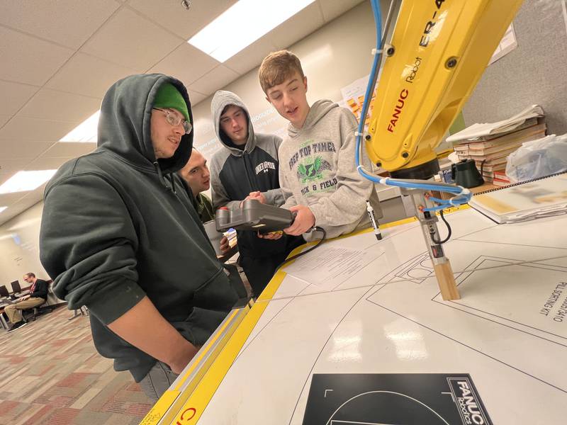 Yorkville High School received honors for its computer science, engineering, and biomedical programs. Pictured, Yorkville High School Engineering teacher, John Alaniz, helps students prepare for a class project.