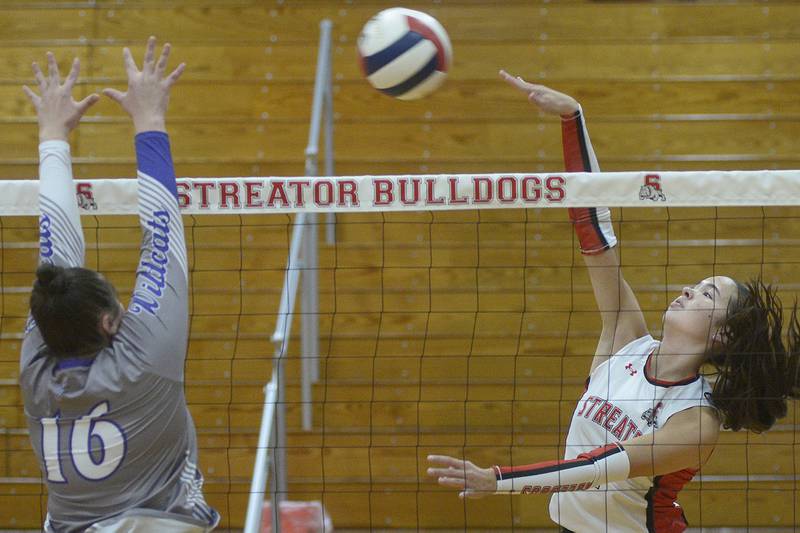 Streator’s Aubrey Jacobs sets to get a tip ball past the block by Wilmington’s Melia Hincherick in the 1st set Thursday at Streator.