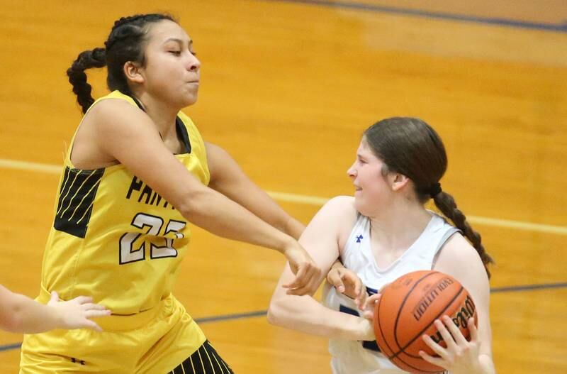 Princeton's Camryn Driscoll grabs a rebound over Putnam County's Valeria Villagomez during the Princeton Holiday Girls Basketball Tournament on Tuesday, Nov. 19, 2024 at Princeton High School.