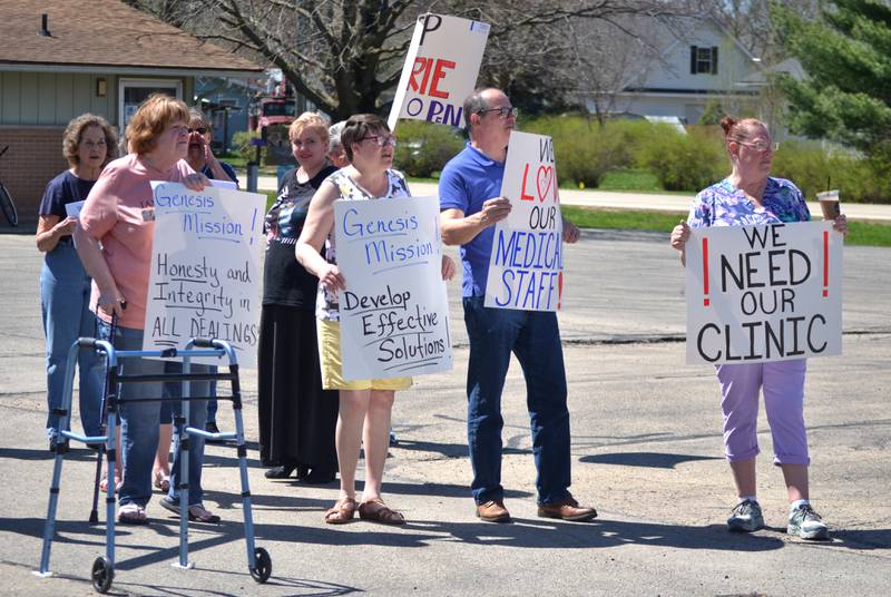Demonstrators hold up signs of support at the Genesis Health Group, Erie Family Clinic parking lot on Thursday, April 13, 2023. Nearly 50 people rallied for the community’s only health care clinic after Genesis announced it will be closed on June 16.