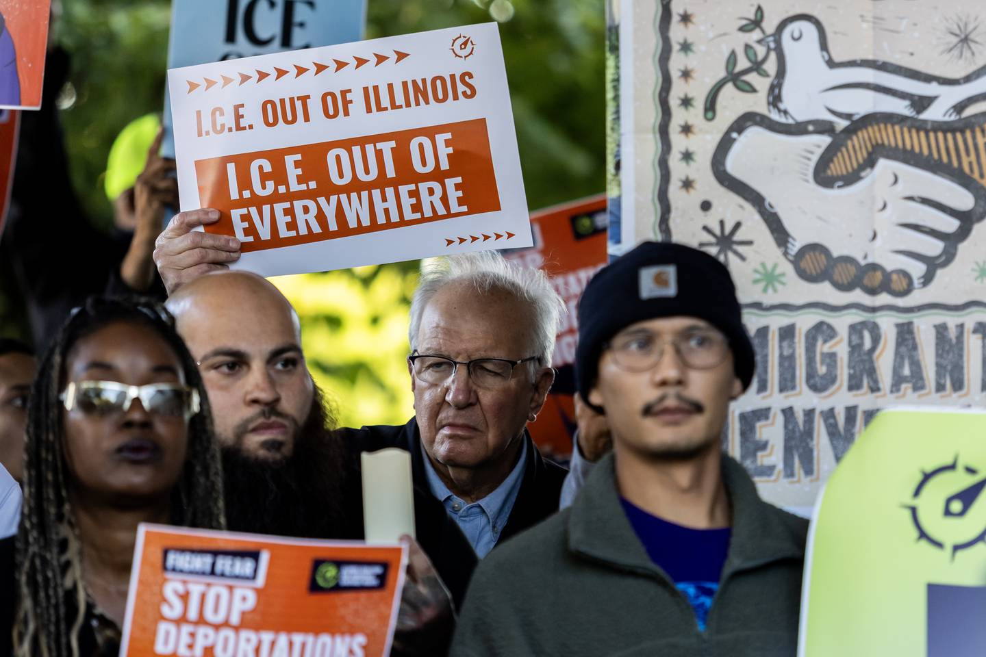 Former Illinois State Senator Pat McGuire holds a sign during a press conference held to uplift immigrant families and denounce the presence of the Texas National Guard in Will County at Azteca de Oro in Joliet on Oct. 8, 2025.
