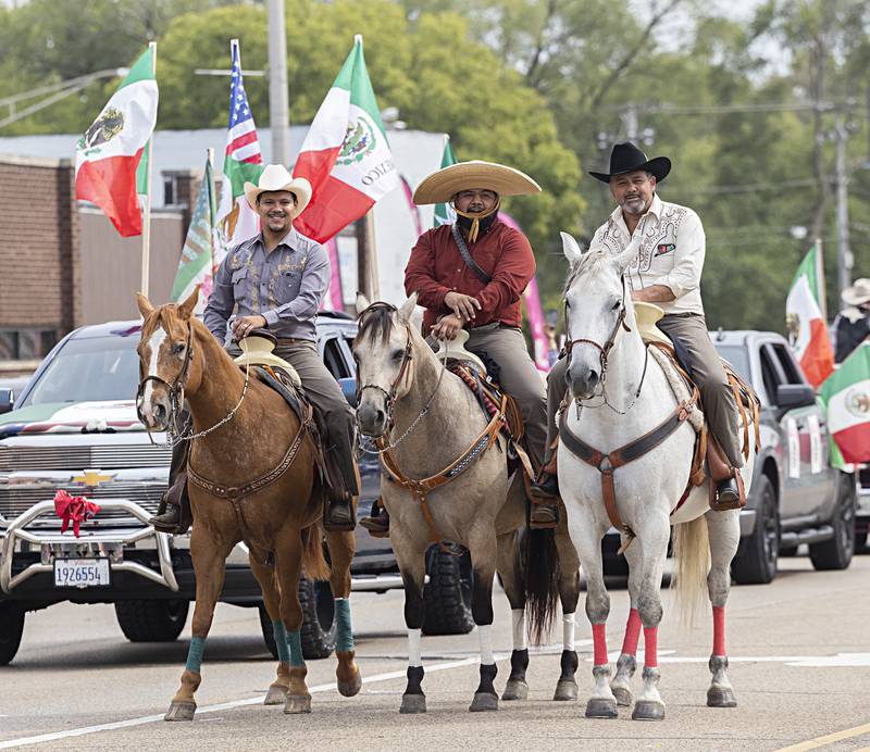Gauchos pose for pictures from atop their horses Saturday, Sept. 16, 2023 during the Sauk Valley Fiesta Days parade.