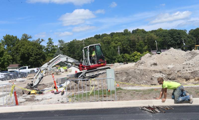 A crew works at the site of the retail plaza called Market on Mill on Tuesday, Aug. 13, 2024 downtown Utica.