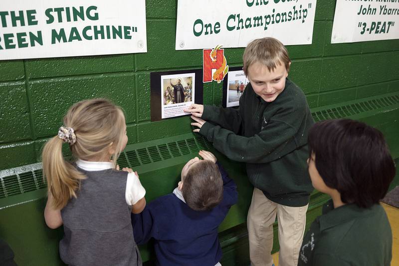 Sixth grader Riley Mattox teaches younger classmates about about St. Francis Xavier on Thursday, Feb. 2, 2023 at St. Andrew Catholic School in Rock Falls. The school has had a full slate of fun and learning activities planned for Catholic Schools Week.