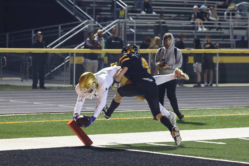 Herscher's Peyton Clark pushes Bishop McNamara's Coen Demack out of bounds to prevent a touchdown during the Fightin' Irish's 45-28 victory over the Tigers on Friday, Sept. 5, 2025.