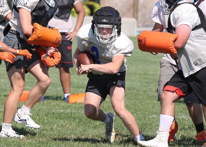 Genoa-Kingston's Ethan Wilnau gets through the line Wednesday, Aug.10, 2022, during practice at the school in Genoa.