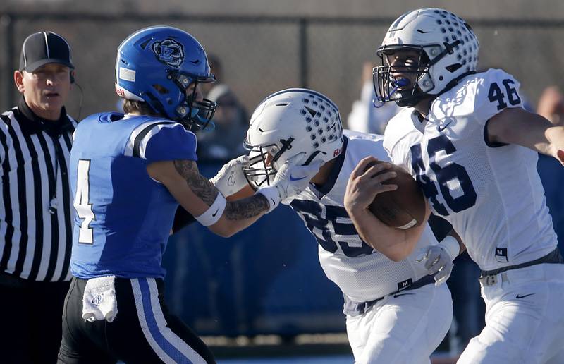 Cary-Grove's Logan Abrams scores a touchdown as Lake Zurich's Nolan Siko grabs Cary-Grove's Luca Vivadelli during a IHSA Class 6A semifinal playoff football game on Saturday, Nov. 18, 2023, at Lake Zurich High School.